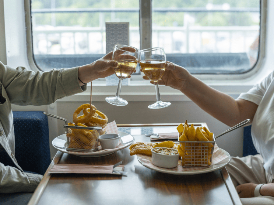2 hands cheering a glass of wine